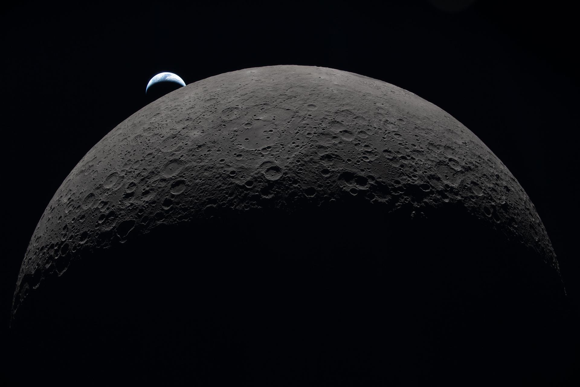 Earth sets at 6:41 p.m. EDT, April 6, 2026, over the Moon’s curved limb in this photo captured ...