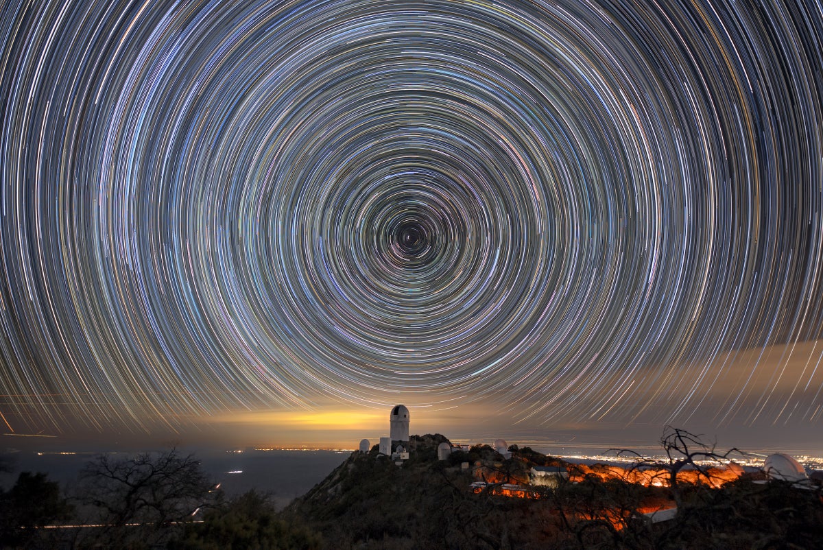 Blended_Northern_Startrail_from_WIYN-CC2-resized Star trails over the Mayall Telescope that houses DESI. Luke Tyas/Berkeley Lab and KPNO/NOIRLab/N...