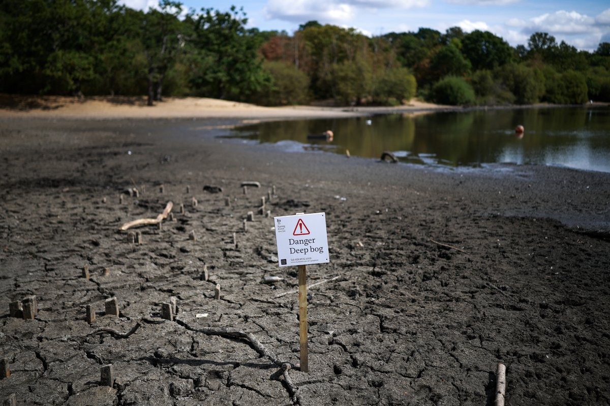 The dried and cracked bed of the depleted Hollow Pond and Leyton Flats near the area of Wanstead ...