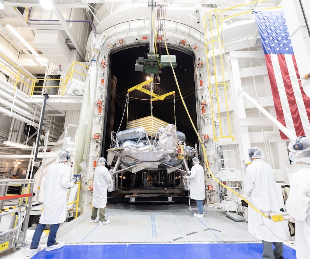 Engineers and technicians use a crane to position Voyager Technologies’ Griffin-1 lunar lander ...