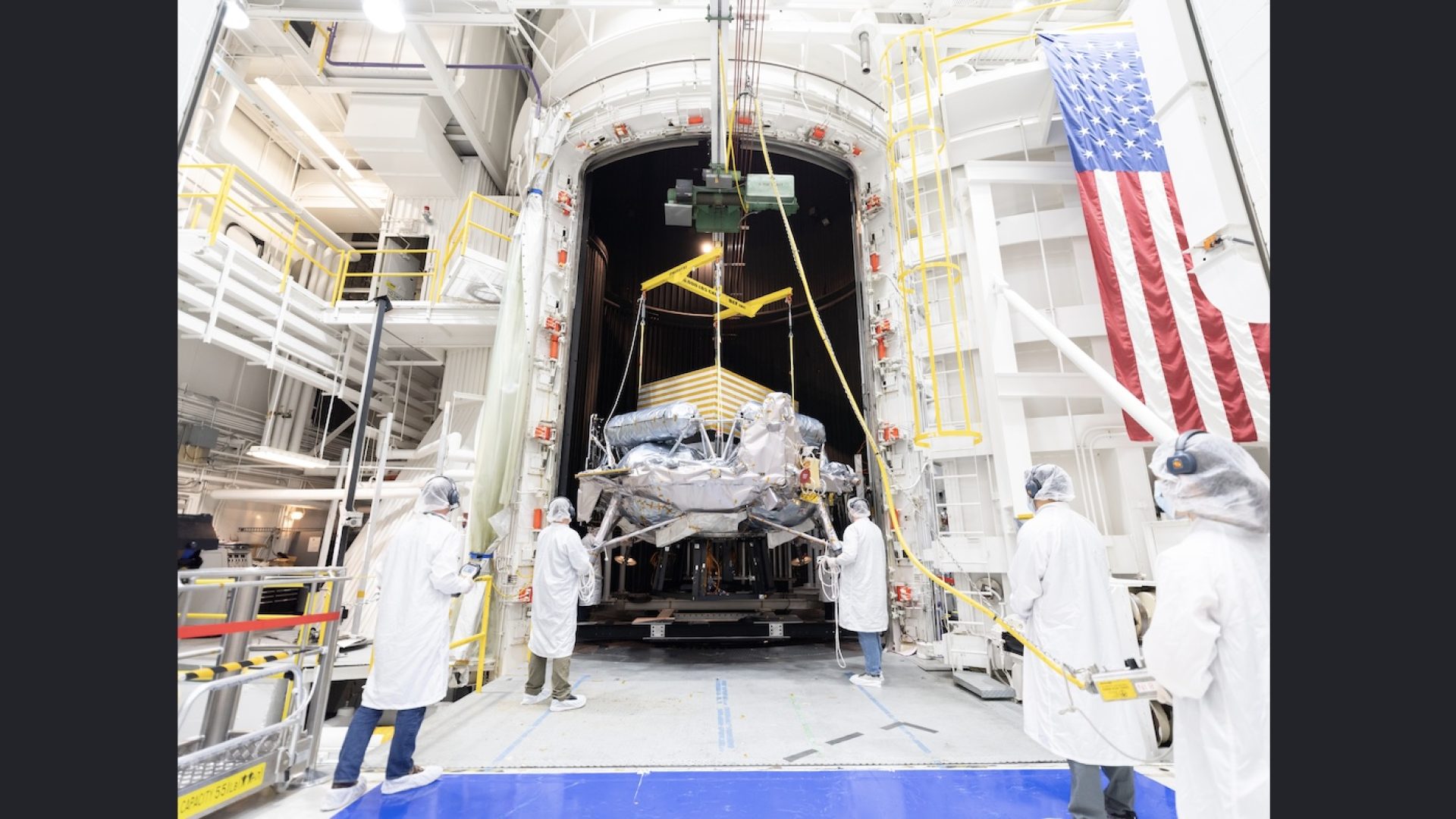 Engineers and technicians use a crane to position Voyager Technologies’ Griffin-1 lunar lander ...