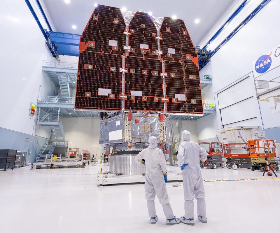 In a clean room at at NASA’s Goddard Space Flight Center, technicians view the Goddard-built $4...