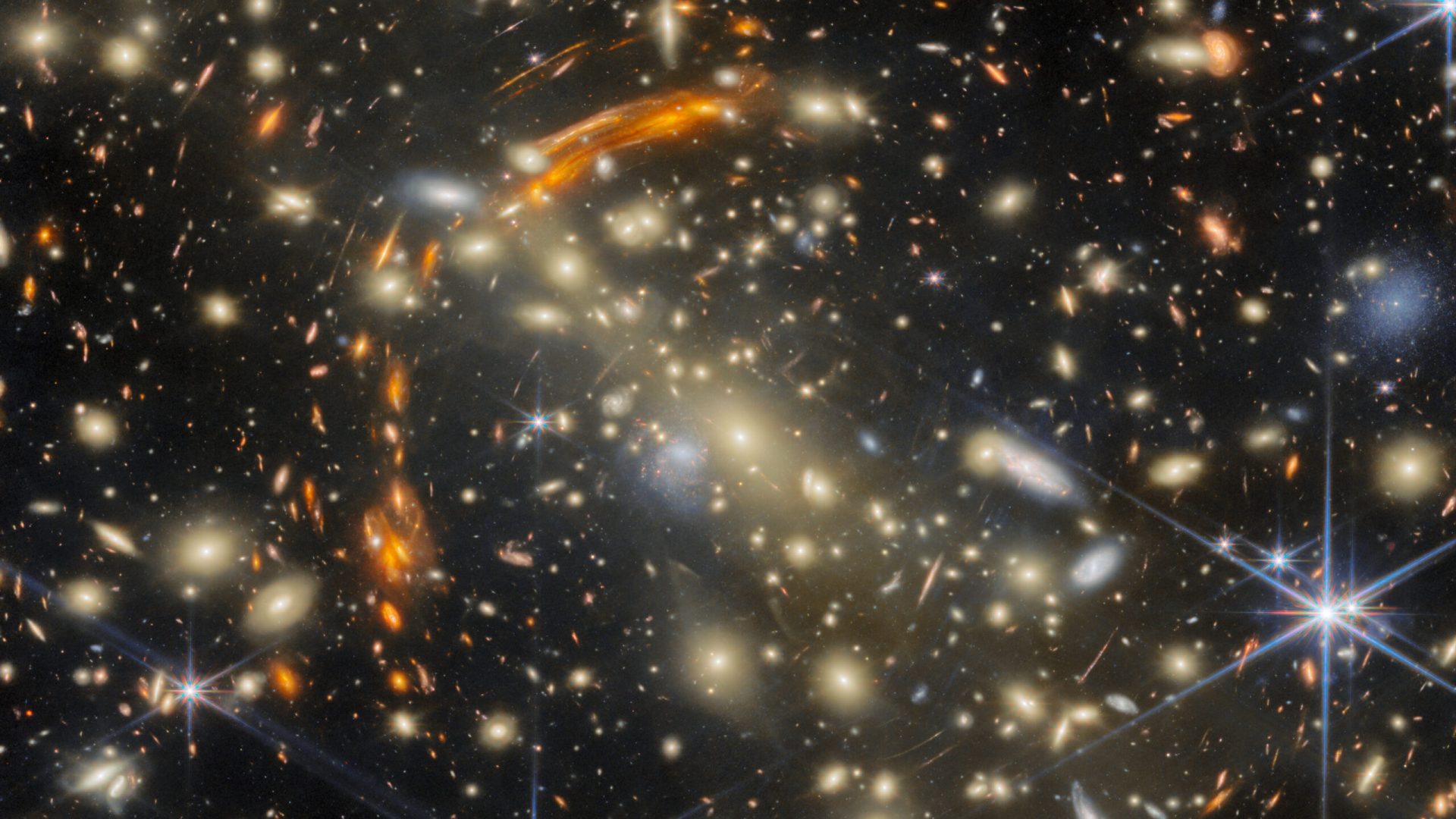 A massive galaxy cluster, made of many golden elliptical galaxies with the largest, brightest one...