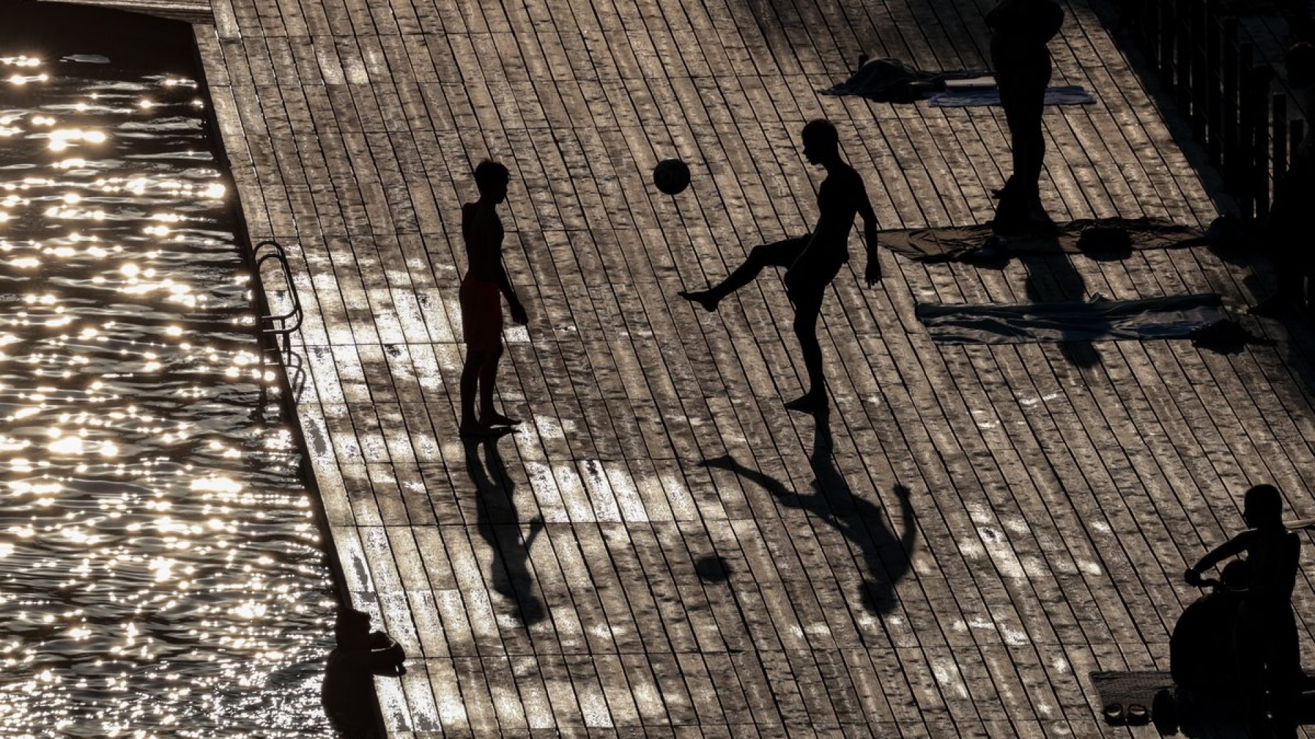 Visitors to Zakrzówek Lake in Kraków, Poland, cool down in water as a heat wave moves to the na...
