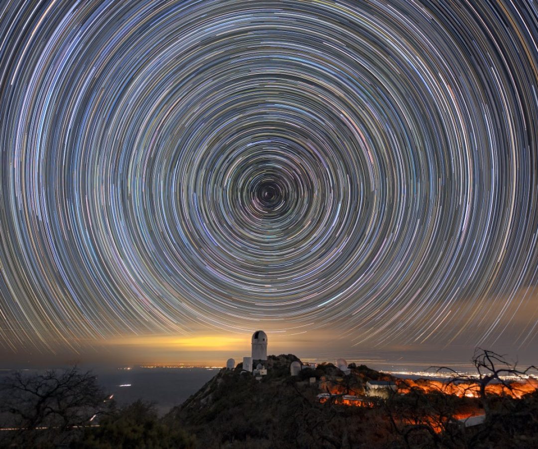 Star trails over the Mayall Telescope that houses DESI. Luke Tyas/Berkeley Lab and KPNO/NOIRLab/N...