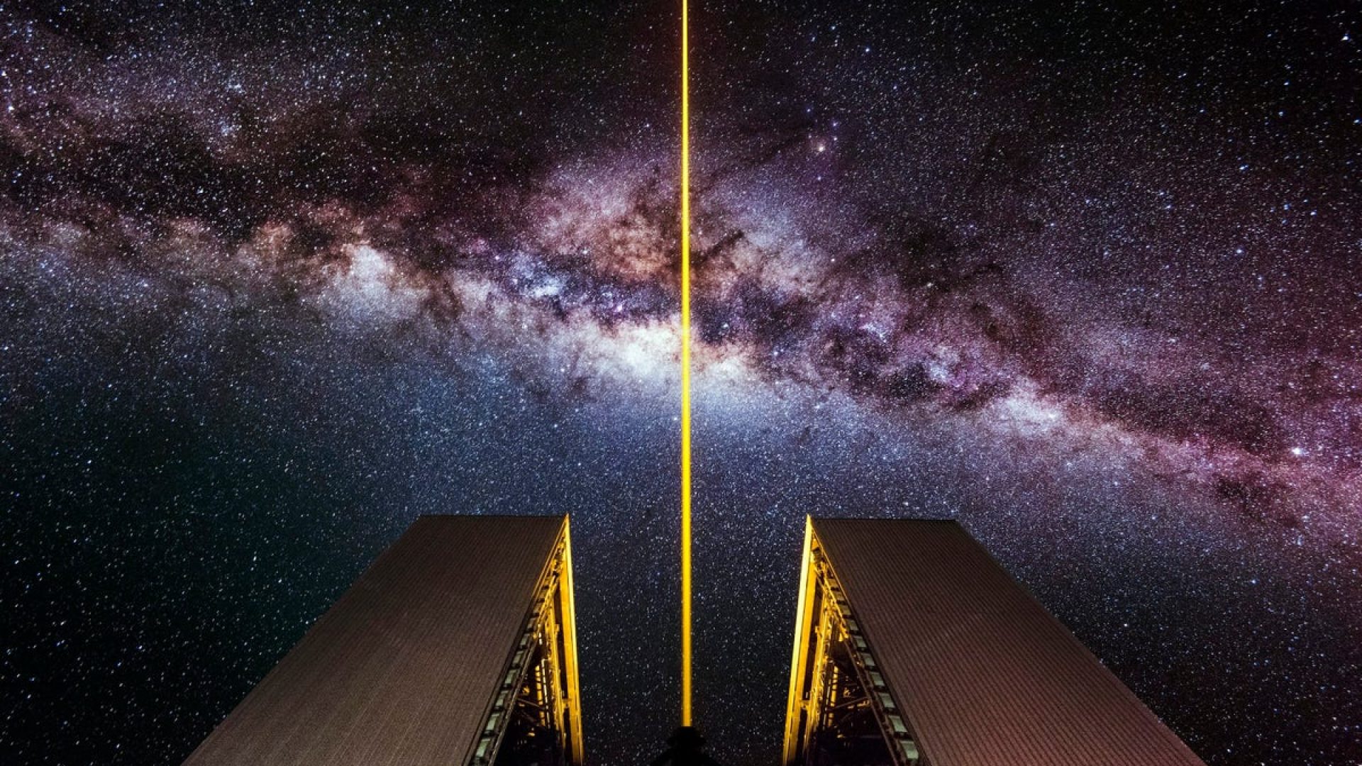 A laser shoots into the night sky from an 8.2-meter optical telescope at the European Southern Ob...
