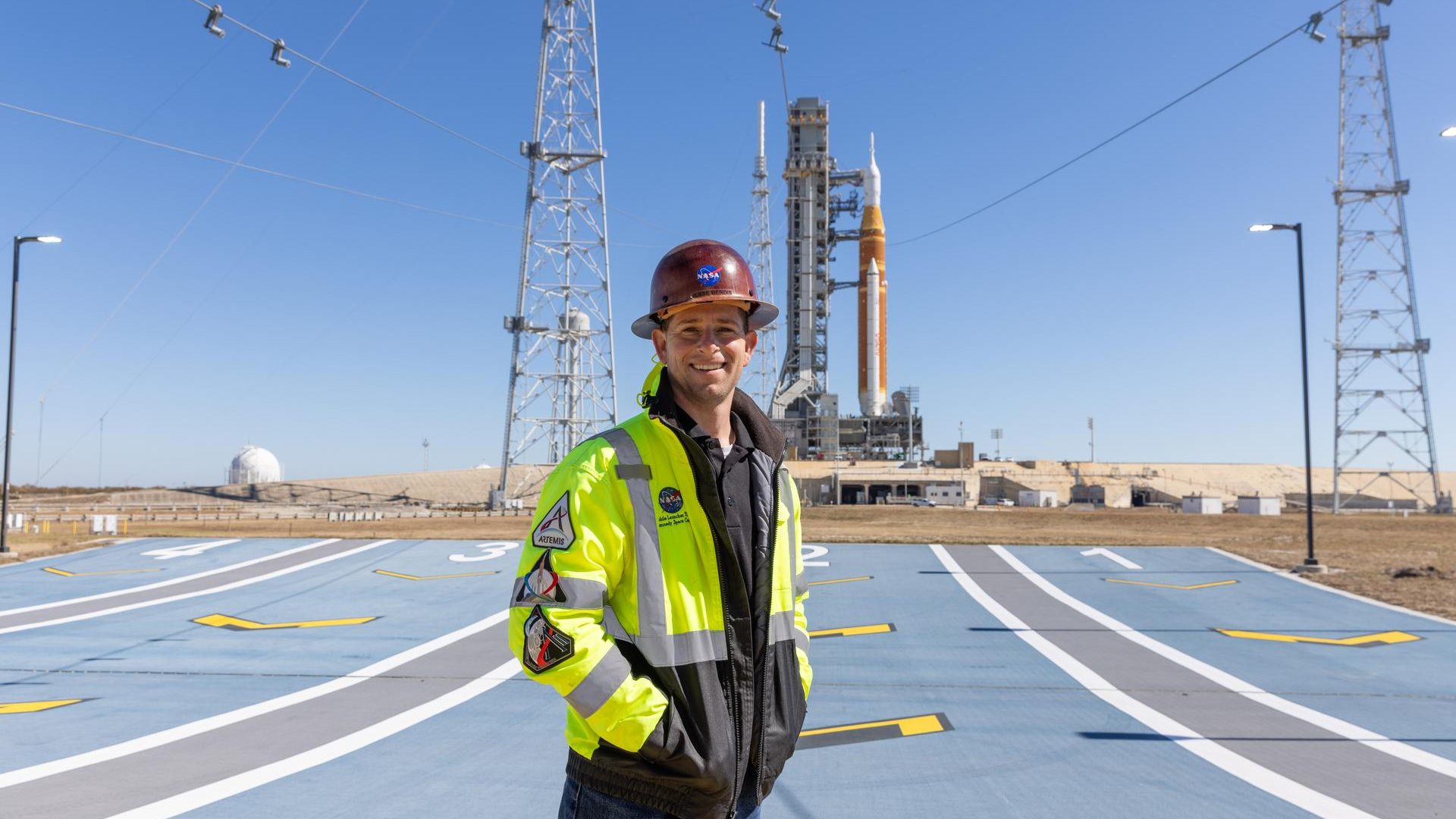 Image shows Jesse Berdis standing standing at the pad of Launch Complex 39B at NASA's Kennedy Spa...
