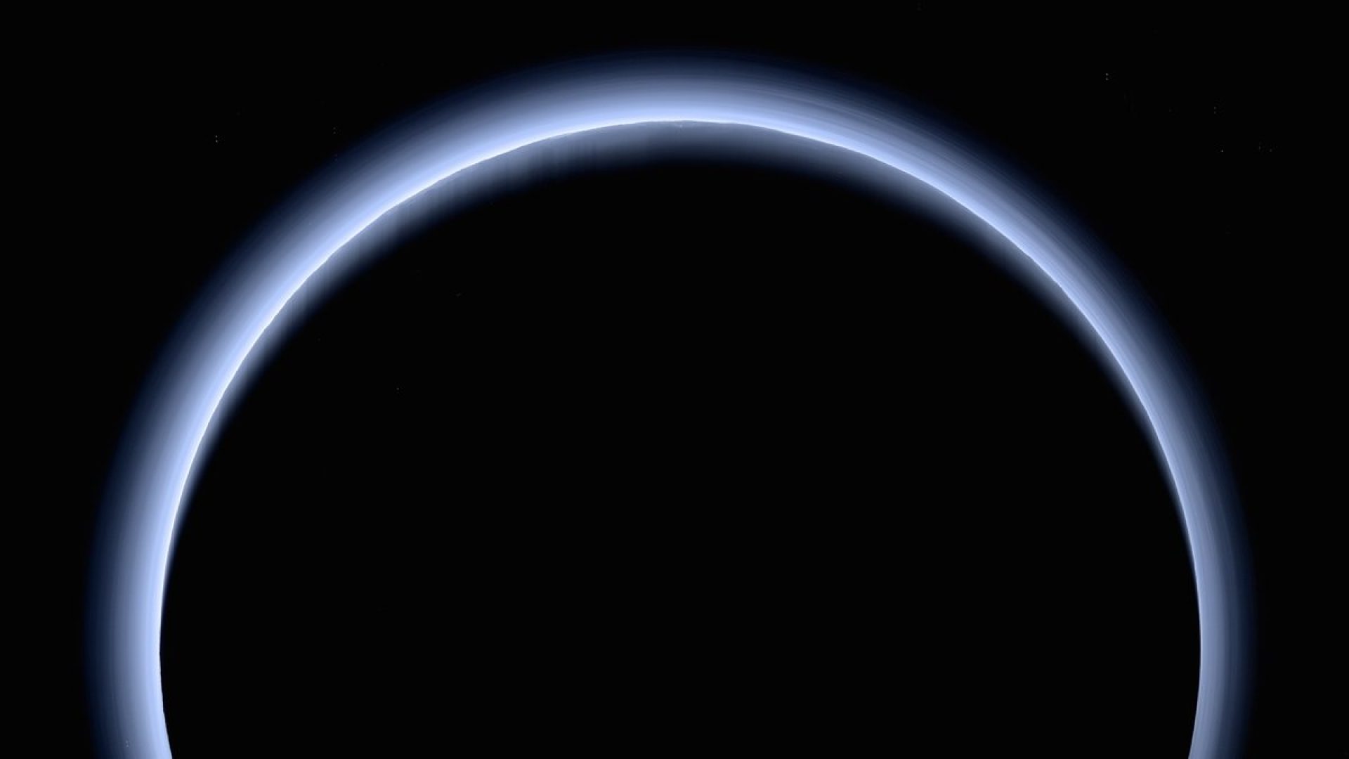 Pluto’s thin, hazy atmosphere shows its blue color in this view from NASA’s New Horizons prob...