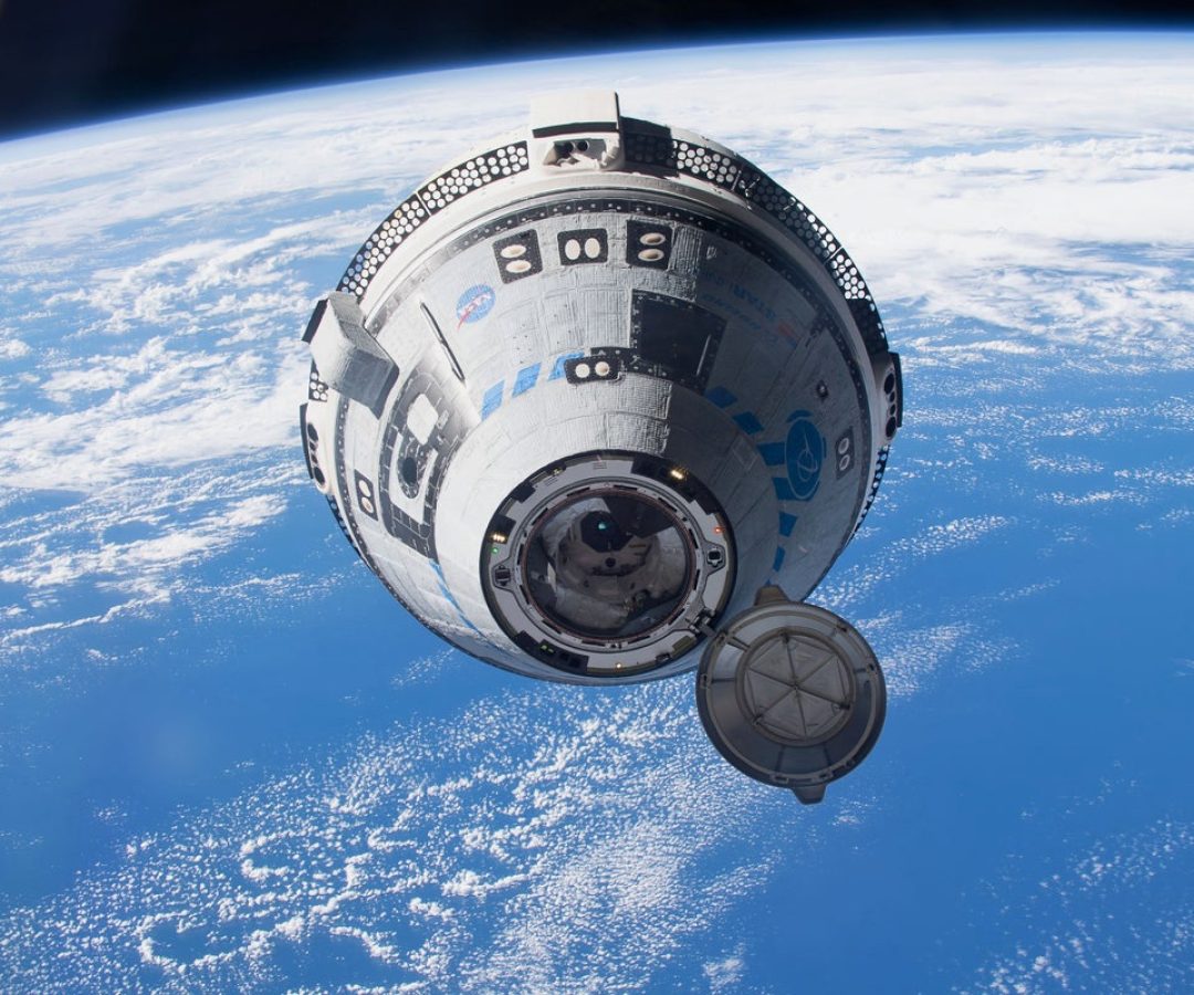 Boeing’s CST-100 Starliner ship approaches the International Space Station during the uncrewed ...