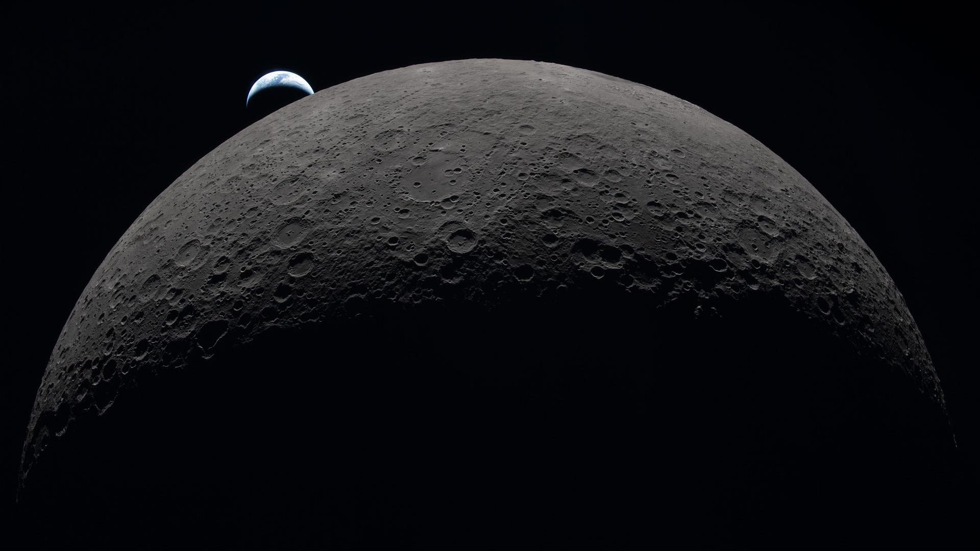 Earth sets at 6:41 p.m. EDT, April 6, 2026, over the Moon’s curved limb in this photo captured ...