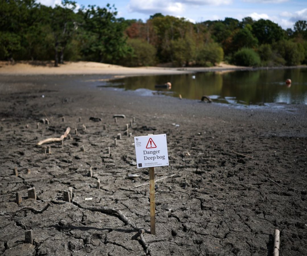 The dried and cracked bed of the depleted Hollow Pond and Leyton Flats near the area of Wanstead ...