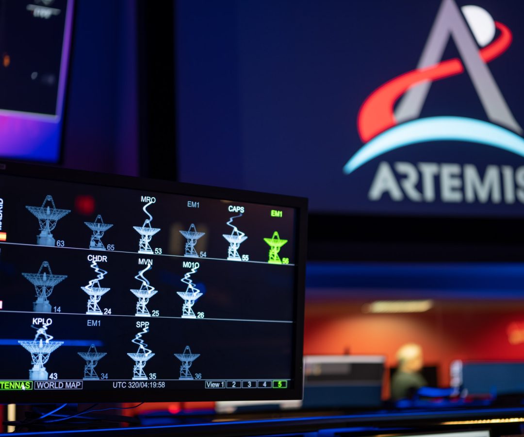 The DSN Now tool is displayed on a screen in the foreground—antenna images show real-time data ...