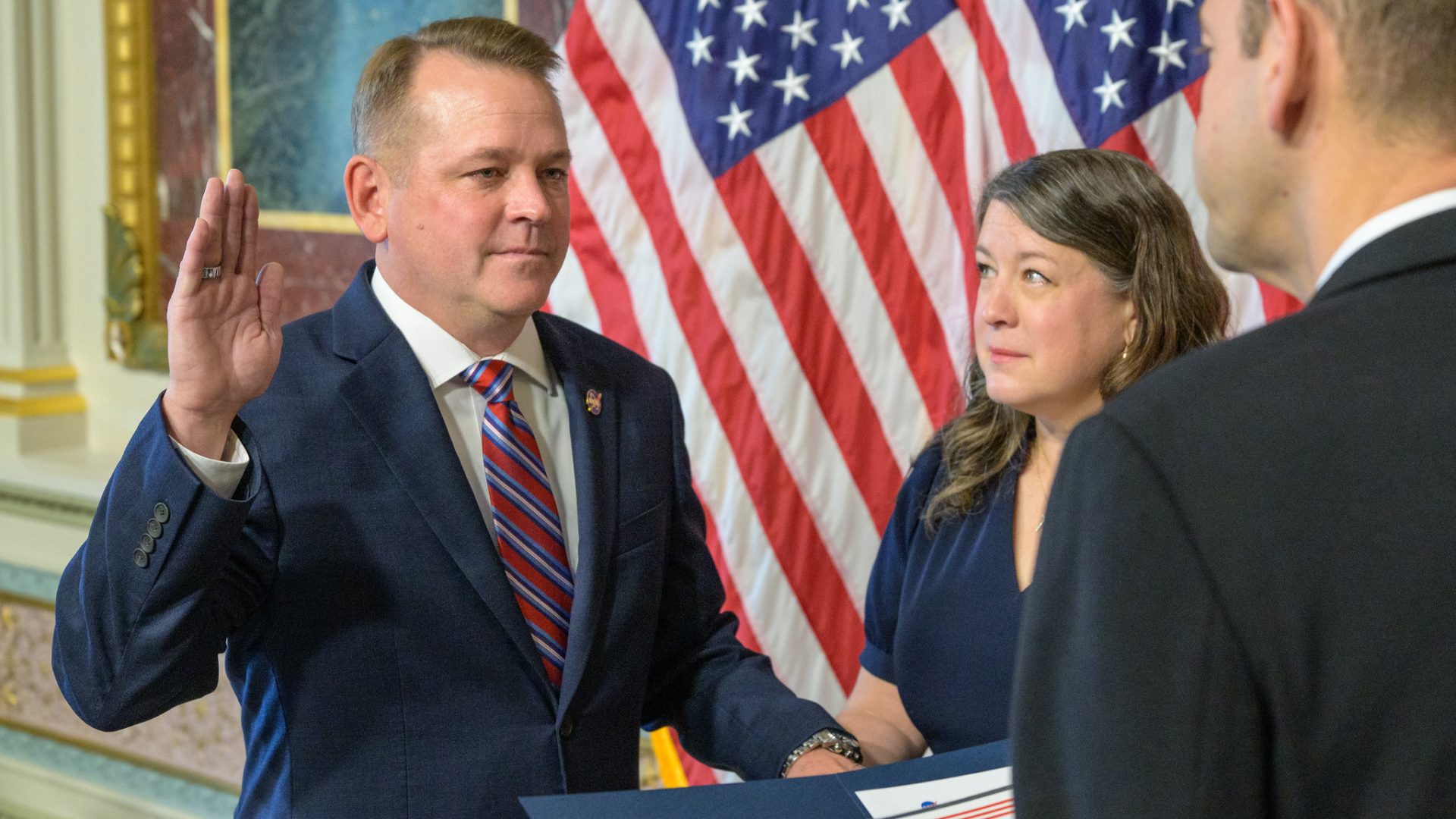 Matt Anderson, left, joined by his wife Christine, is sworn in as the 16th deputy administrator o...