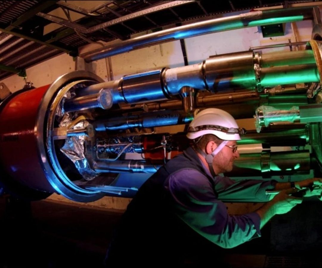An engineer works on equipment for the LHCb experiment inside the tunnel of the Large Hadron Coll...