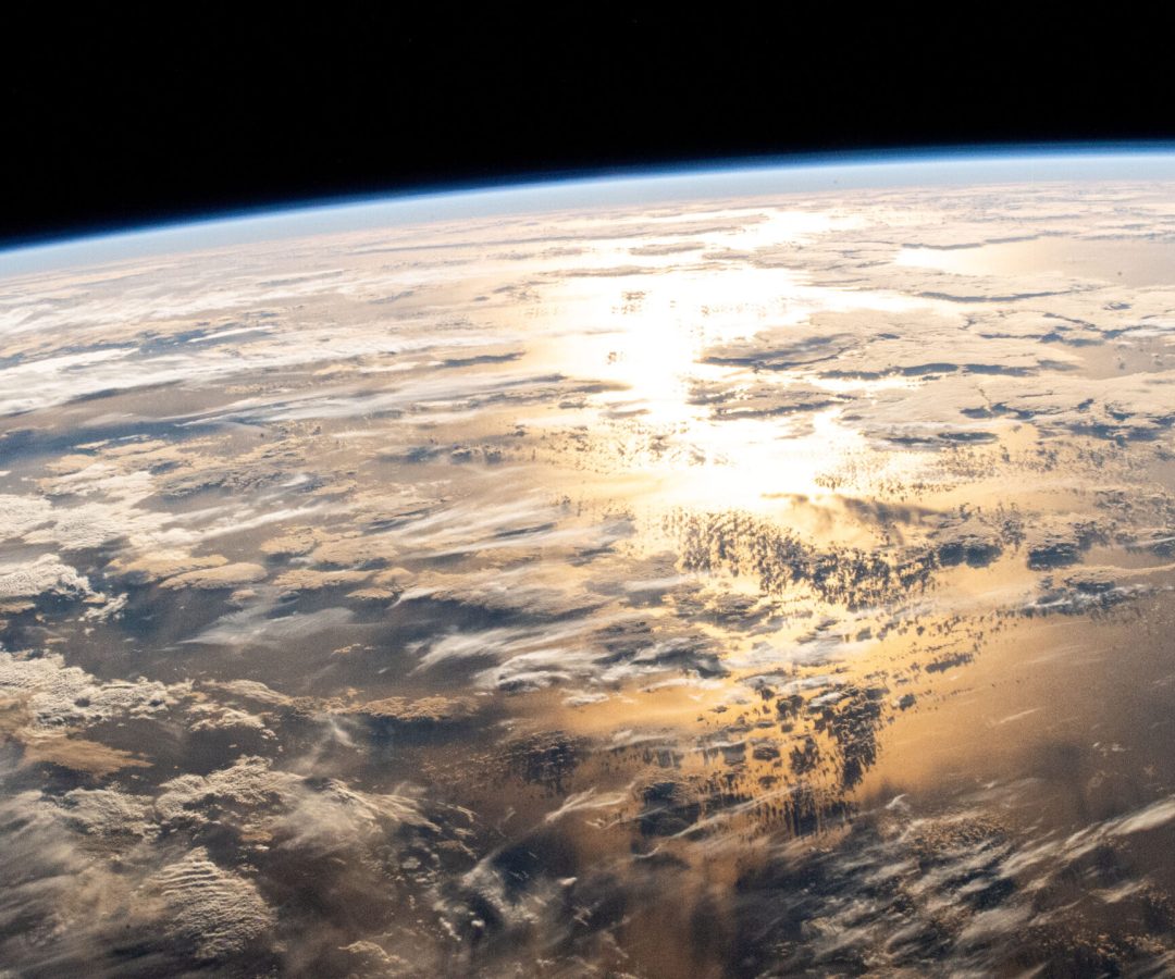 A view of the Atlantic Ocean from the International Space Station. Sun shines on the water, turni...