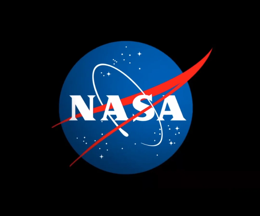 The letters NASA on a blue circle with red and white detail, all surrounded by a black background