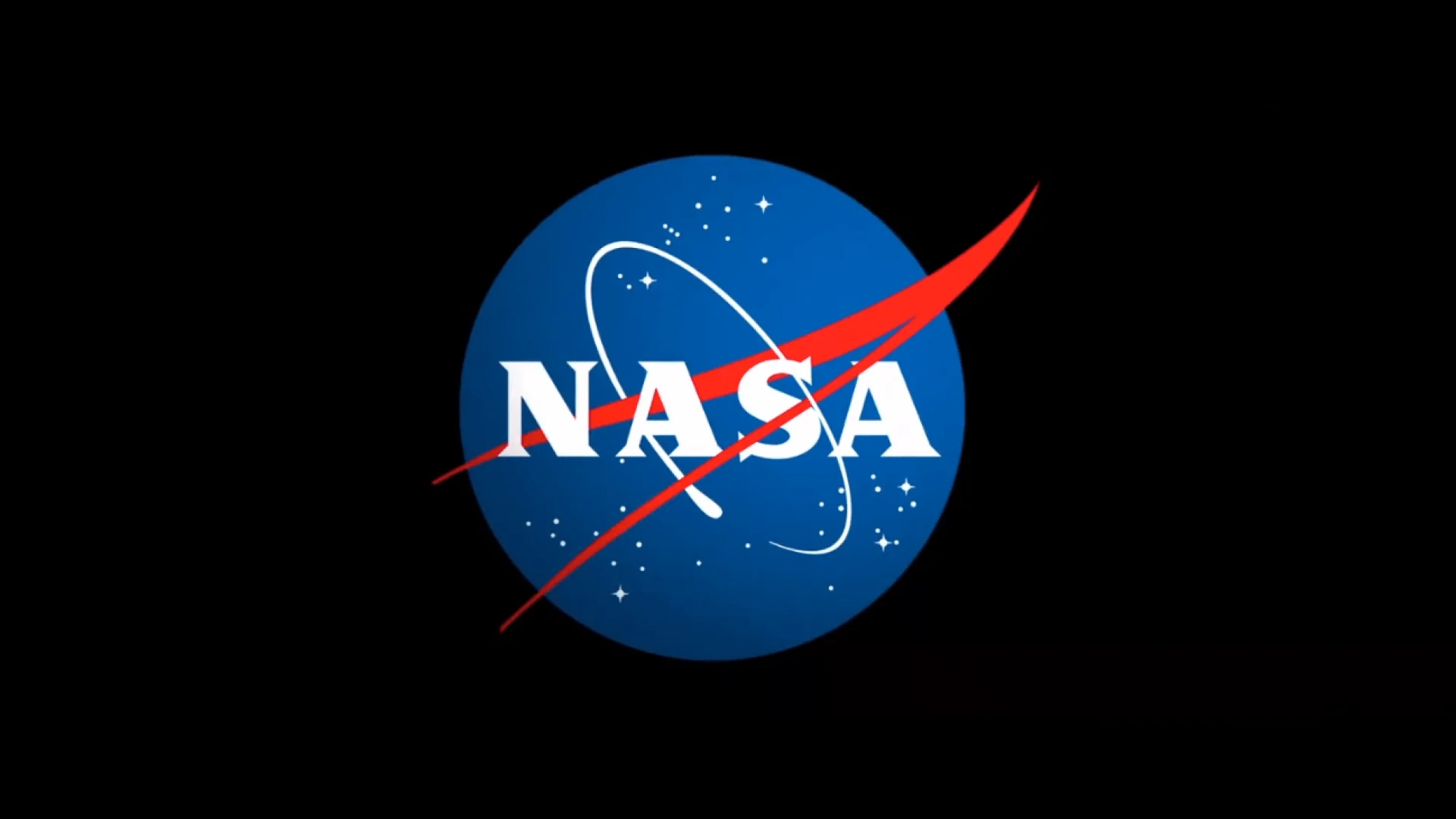 The letters NASA on a blue circle with red and white detail, all surrounded by a black background