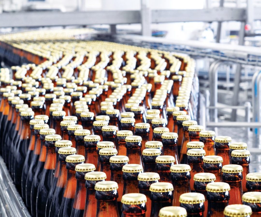 Beer moves down a brewery conveyor belt. industryview/Getty Images